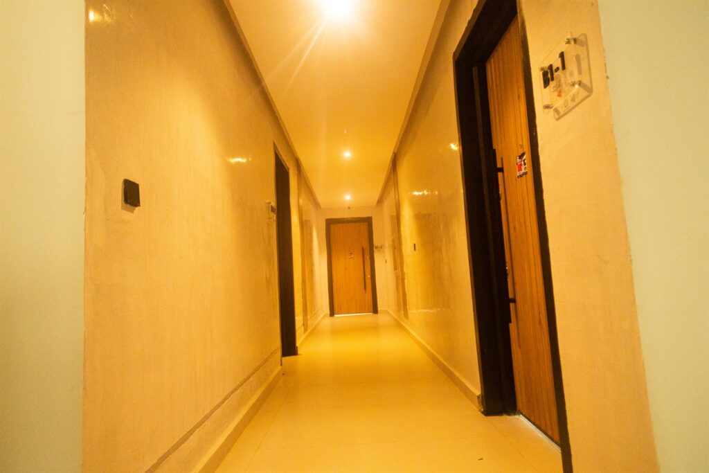 Brum Height 7: Warmly lit internal corridor with apartment doors